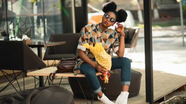 woman-in-brown-and-gray-t-shirt-sitting-on-brown-wooden-949670 fashion brand